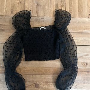 Black, balloon sleeve, crop with polka dot detailing on sleeve.